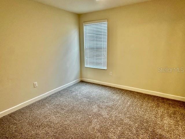 1513 Maidstone Ct, Davenport, FL 33896 - carpeted empty room with baseboards