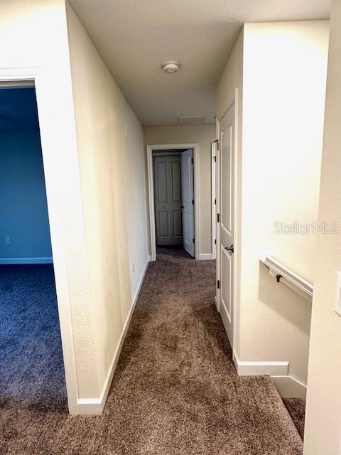 1513 Maidstone Ct, Davenport, FL 33896 - hallway with carpet flooring and baseboards