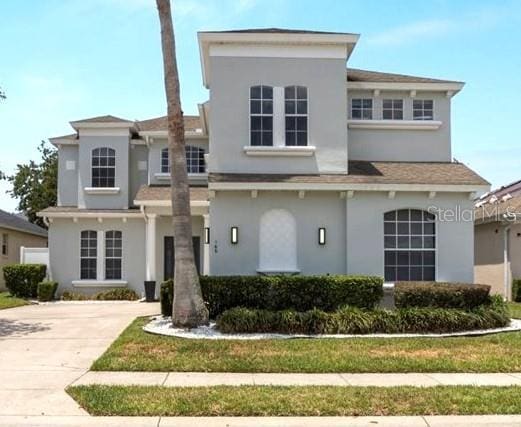 166 Minniehaha Cir, Haines City, FL 33844 - view of front of home with stucco siding and driveway