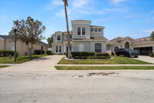 166 Minniehaha Cir, Haines City, FL 33844 - view of front of property featuring concrete driveway, stucco siding, and a front yard