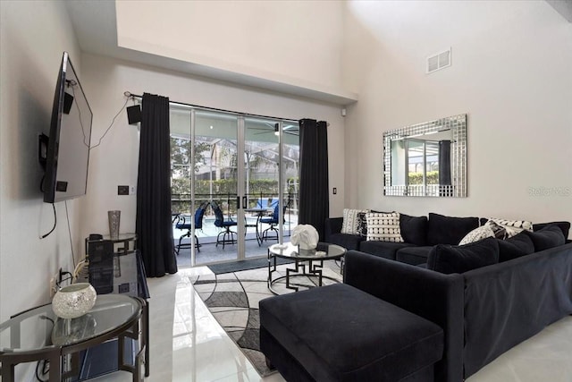 166 Minniehaha Cir, Haines City, FL 33844 - living area featuring healthy amount of natural light, light tile patterned flooring, and a towering ceiling