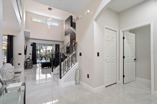 166 Minniehaha Cir, Haines City, FL 33844 - foyer with arched walkways, plenty of natural light, baseboards, marble finish floors, and a towering ceiling