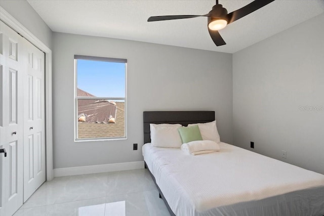 166 Minniehaha Cir, Haines City, FL 33844 - bedroom featuring a closet, ceiling fan, marble finish floors, and baseboards