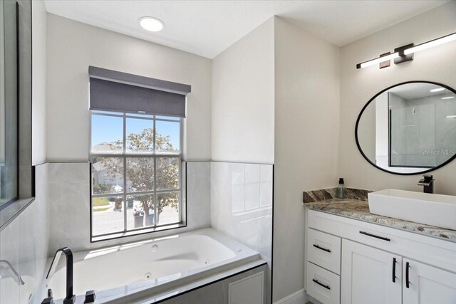 166 Minniehaha Cir, Haines City, FL 33844 - full bathroom featuring vanity and a tub with jets