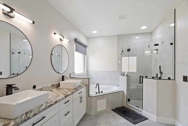 166 Minniehaha Cir, Haines City, FL 33844 - bathroom with a garden tub, a stall shower, double vanity, and recessed lighting