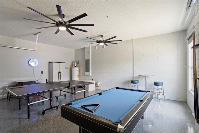 166 Minniehaha Cir, Haines City, FL 33844 - game room featuring concrete block wall, a textured ceiling, gas water heater, ceiling fan, and speckle patterned floor