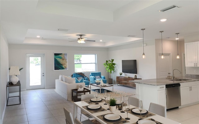 dining space with a raised ceiling, a ceiling fan, light tile patterned floors, and recessed lighting