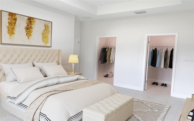 bedroom with a spacious closet, a closet, and baseboards