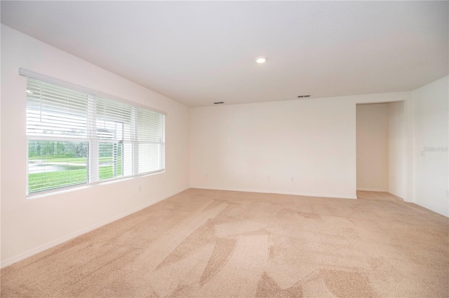 unfurnished room featuring light colored carpet, baseboards, and recessed lighting