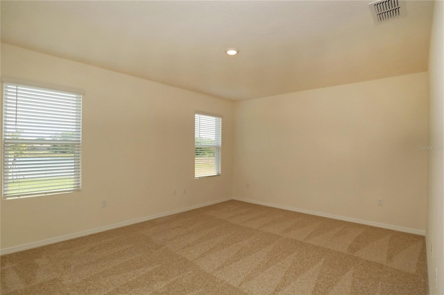 unfurnished room with light carpet, baseboards, and recessed lighting