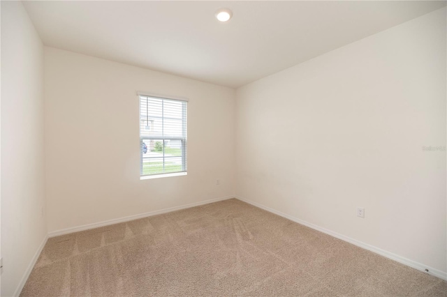 carpeted empty room with baseboards and recessed lighting
