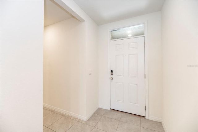 entrance foyer featuring light tile patterned flooring and baseboards