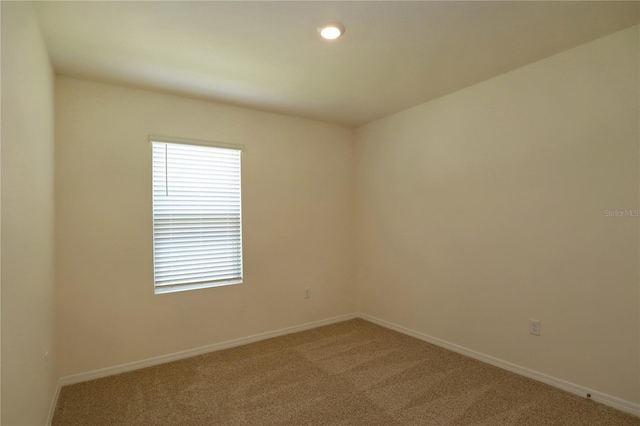 spare room with carpet floors, baseboards, and recessed lighting