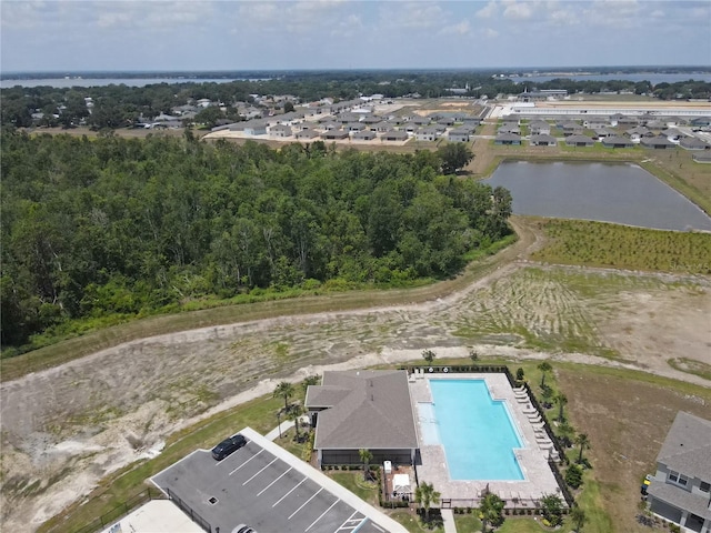 aerial view of a pool and a nearby body of water