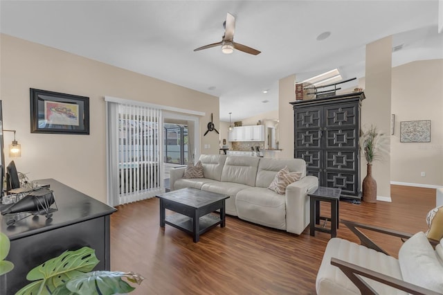 living area with ceiling fan, wood finished floors, lofted ceiling, and baseboards