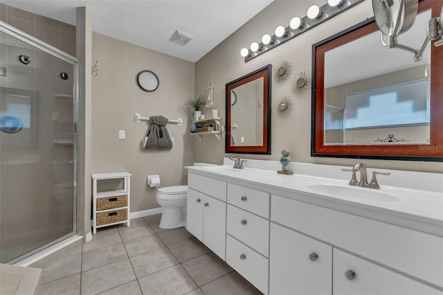 bathroom with toilet, a shower stall, tile patterned flooring, double vanity, and baseboards