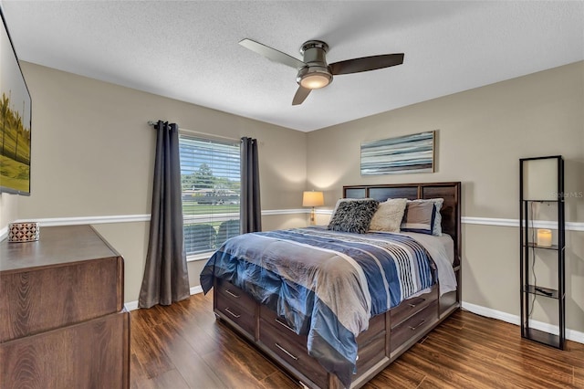 bedroom featuring dark wood-style floors, baseboards, a ceiling fan, and a textured ceiling