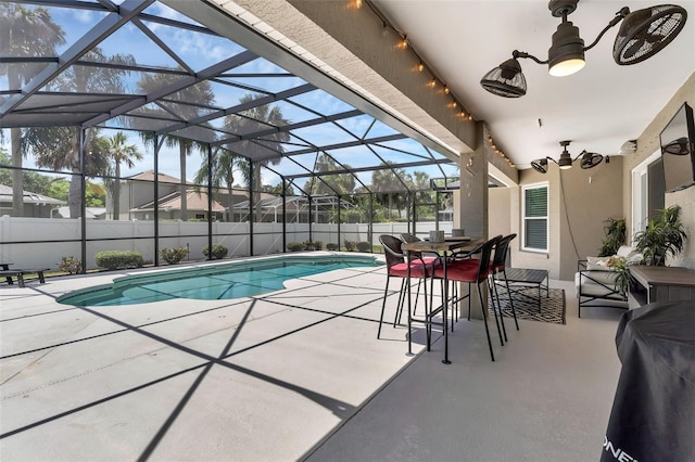 view of swimming pool with a patio, a fenced backyard, and glass enclosure