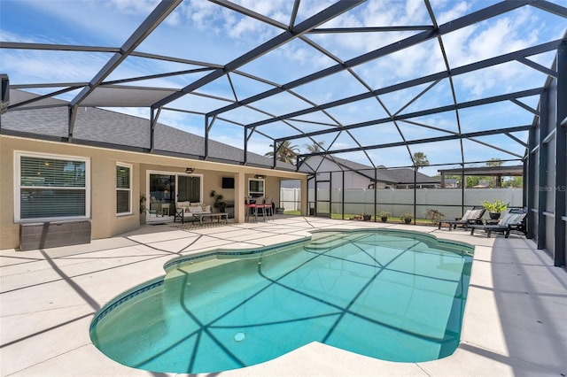view of swimming pool featuring a patio area, fence, and a lanai