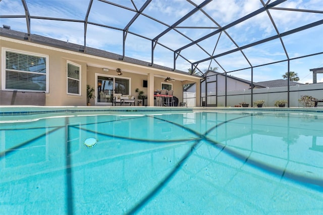 view of pool with a ceiling fan, a patio, and a lanai