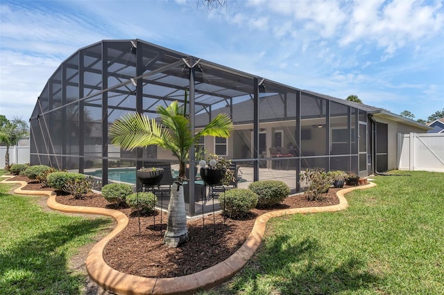 rear view of house with an outdoor pool, a patio, and a lanai