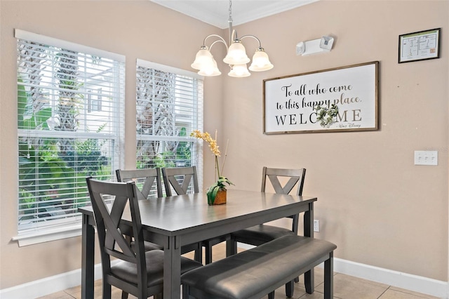 2952 Lucayan Harbour Cir Unit 105, Kissimmee, FL 34746 - dining area featuring a chandelier, baseboards, light tile patterned flooring, and ornamental molding