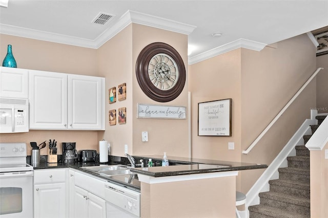 2952 Lucayan Harbour Cir Unit 105, Kissimmee, FL 34746 - kitchen with white appliances, ornamental molding, a peninsula, white cabinetry, and dark countertops