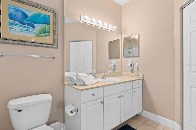 2952 Lucayan Harbour Cir Unit 105, Kissimmee, FL 34746 - bathroom featuring tile patterned floors, toilet, vanity, and baseboards