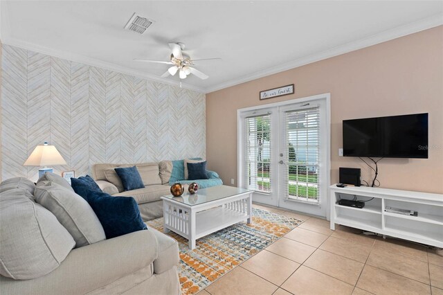 2952 Lucayan Harbour Cir Unit 105, Kissimmee, FL 34746 - living area with wallpapered walls, ornamental molding, ceiling fan, an accent wall, and light tile patterned floors