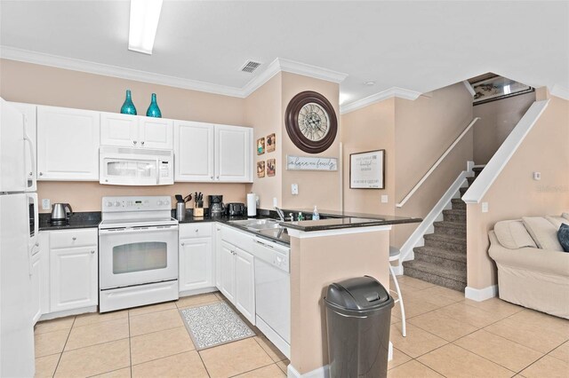 2952 Lucayan Harbour Cir Unit 105, Kissimmee, FL 34746 - kitchen featuring white appliances, a peninsula, light tile patterned floors, crown molding, and white cabinetry