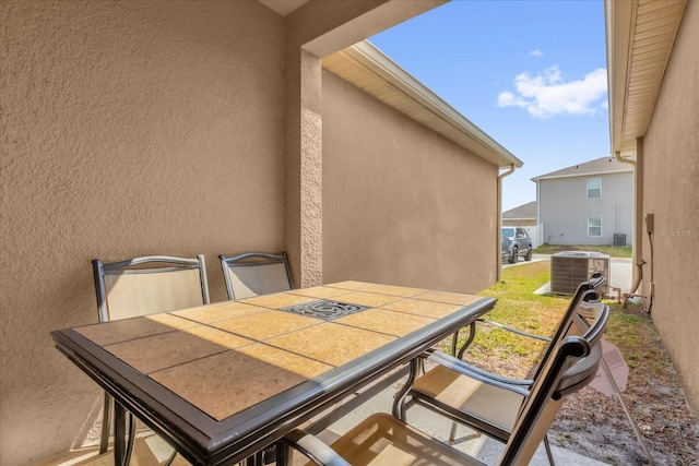 1555 Dawnview Way, Kissimmee, FL 34744 - view of patio featuring outdoor dining space and central AC unit