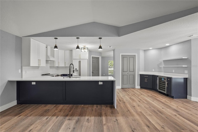1438 Mclin Dr, Plant City, FL 33565 - kitchen featuring open shelves, beverage cooler, a peninsula, a sink, and wall chimney range hood