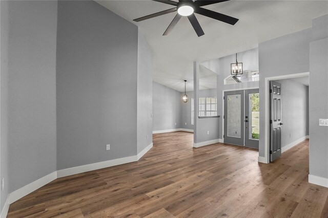 1438 Mclin Dr, Plant City, FL 33565 - foyer featuring ceiling fan, baseboards, high vaulted ceiling, wood finished floors, and a chandelier