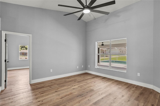 1438 Mclin Dr, Plant City, FL 33565 - spare room featuring high vaulted ceiling, plenty of natural light, and wood finished floors