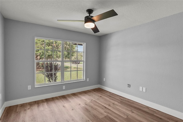 1438 Mclin Dr, Plant City, FL 33565 - empty room with a ceiling fan, wood finished floors, baseboards, and a textured ceiling