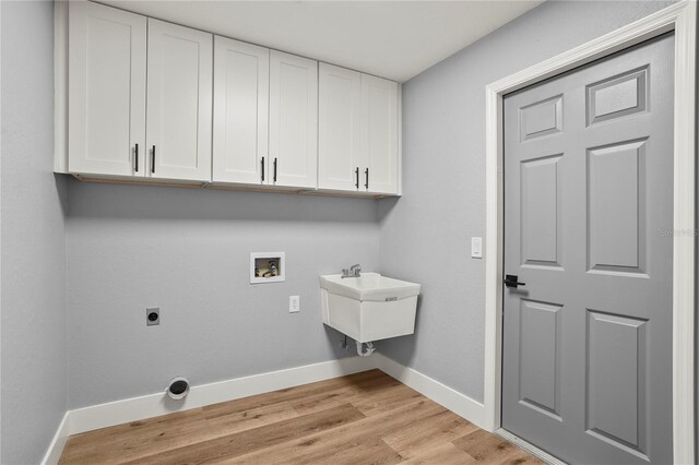 1438 Mclin Dr, Plant City, FL 33565 - laundry area with cabinet space, washer hookup, baseboards, light wood finished floors, and hookup for an electric dryer