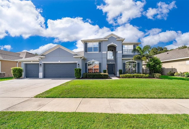 7263 Winding Lake Cir, Oviedo, FL 32765 - traditional-style house with an attached garage, stucco siding, concrete driveway, and a front lawn