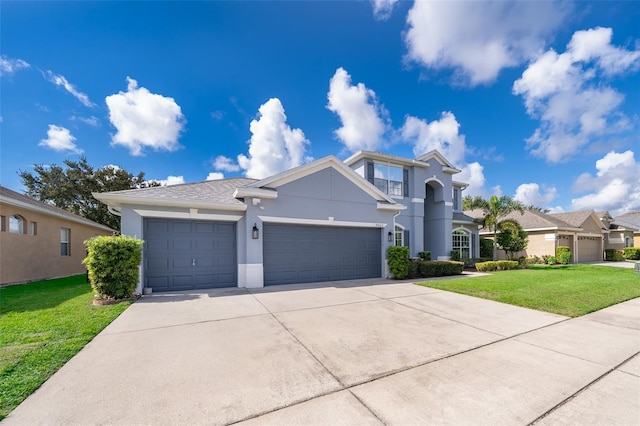 7263 Winding Lake Cir, Oviedo, FL 32765 - view of front of house with an attached garage, stucco siding, a front lawn, and driveway
