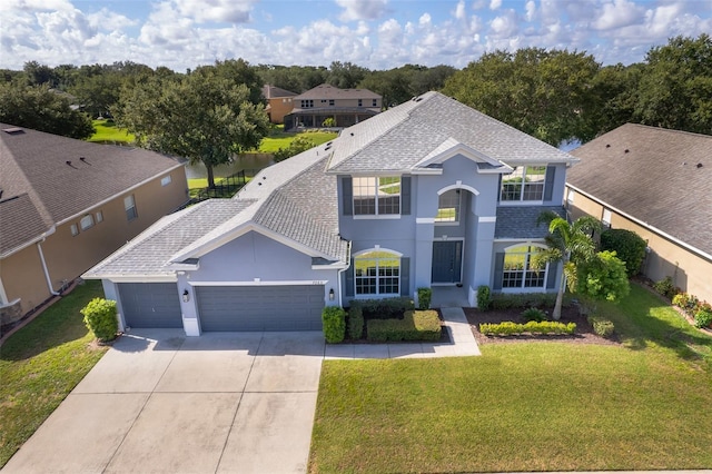 7263 Winding Lake Cir, Oviedo, FL 32765 - traditional home featuring stucco siding, an attached garage, concrete driveway, and a front lawn