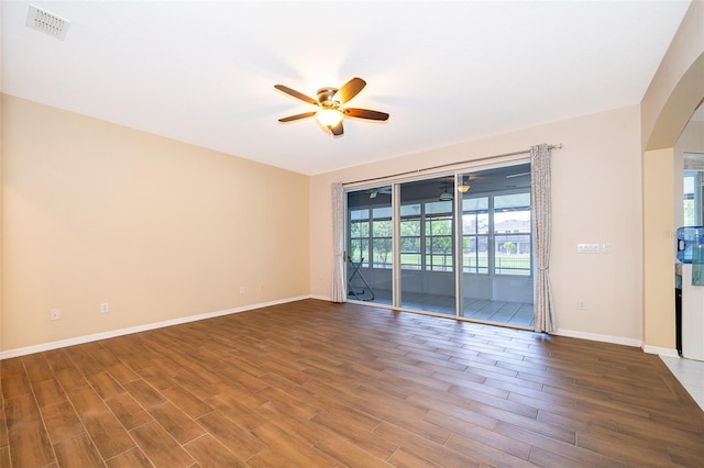 7263 Winding Lake Cir, Oviedo, FL 32765 - unfurnished room featuring ceiling fan, arched walkways, wood finished floors, and baseboards