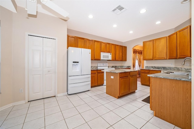 7263 Winding Lake Cir, Oviedo, FL 32765 - kitchen featuring white appliances, a sink, a center island, brown cabinets, and light tile patterned flooring