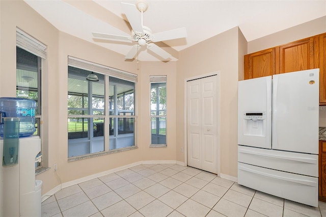 7263 Winding Lake Cir, Oviedo, FL 32765 - unfurnished dining area with light tile patterned floors, a ceiling fan, and baseboards