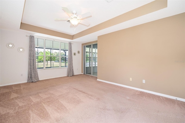 7263 Winding Lake Cir, Oviedo, FL 32765 - empty room featuring a raised ceiling, carpet flooring, ceiling fan, and baseboards