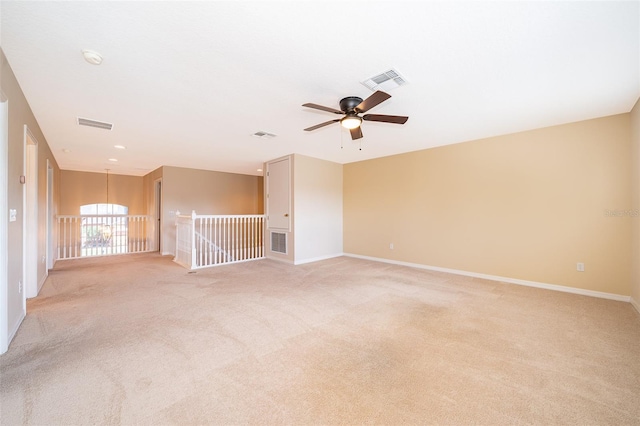 7263 Winding Lake Cir, Oviedo, FL 32765 - empty room featuring light colored carpet, ceiling fan, baseboards, and a chandelier