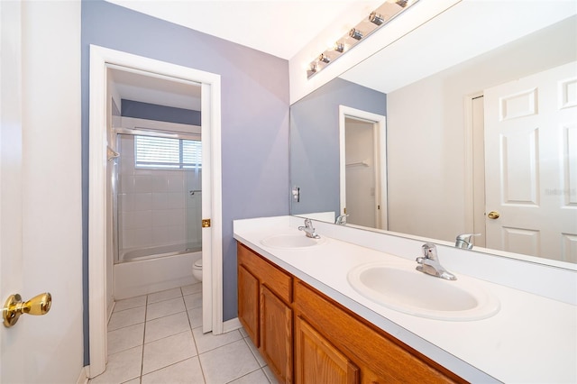 7263 Winding Lake Cir, Oviedo, FL 32765 - full bath with tile patterned flooring, double vanity, baseboards, toilet, and combined bath / shower with glass door