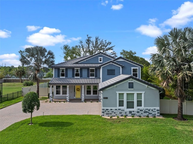 3865 W Stillwood Ln, Lake Mary, FL 32746 - view of front facade featuring covered porch, decorative driveway, a tiled roof, and stucco siding
