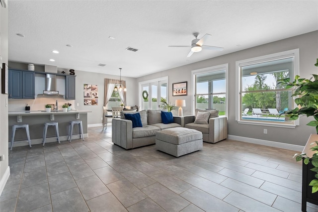 3865 W Stillwood Ln, Lake Mary, FL 32746 - living area featuring a ceiling fan, recessed lighting, baseboards, and a textured ceiling