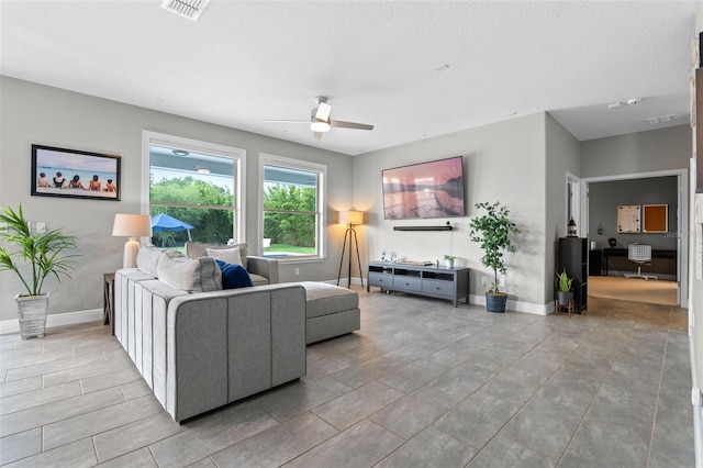 3865 W Stillwood Ln, Lake Mary, FL 32746 - living room with a ceiling fan, baseboards, and a textured ceiling