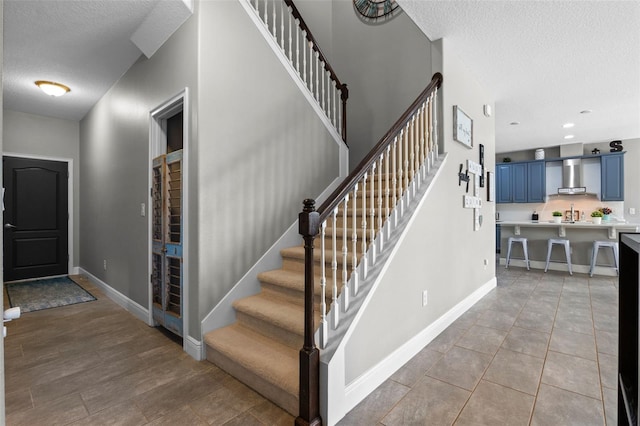 3865 W Stillwood Ln, Lake Mary, FL 32746 - stairway featuring a textured ceiling, baseboards, and tile patterned flooring