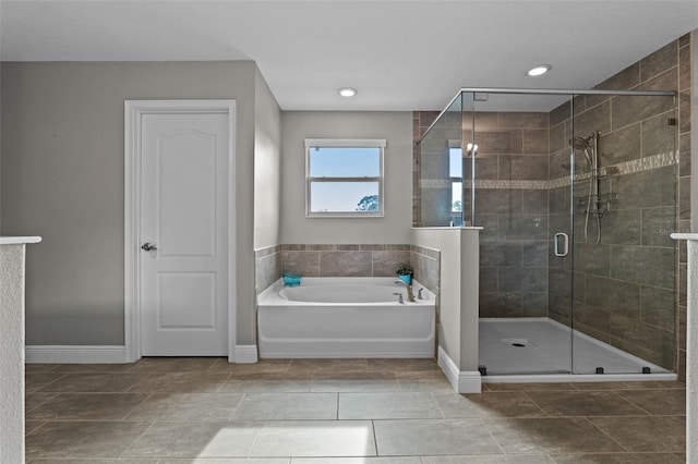 3865 W Stillwood Ln, Lake Mary, FL 32746 - full bathroom with baseboards, a garden tub, a shower stall, and recessed lighting
